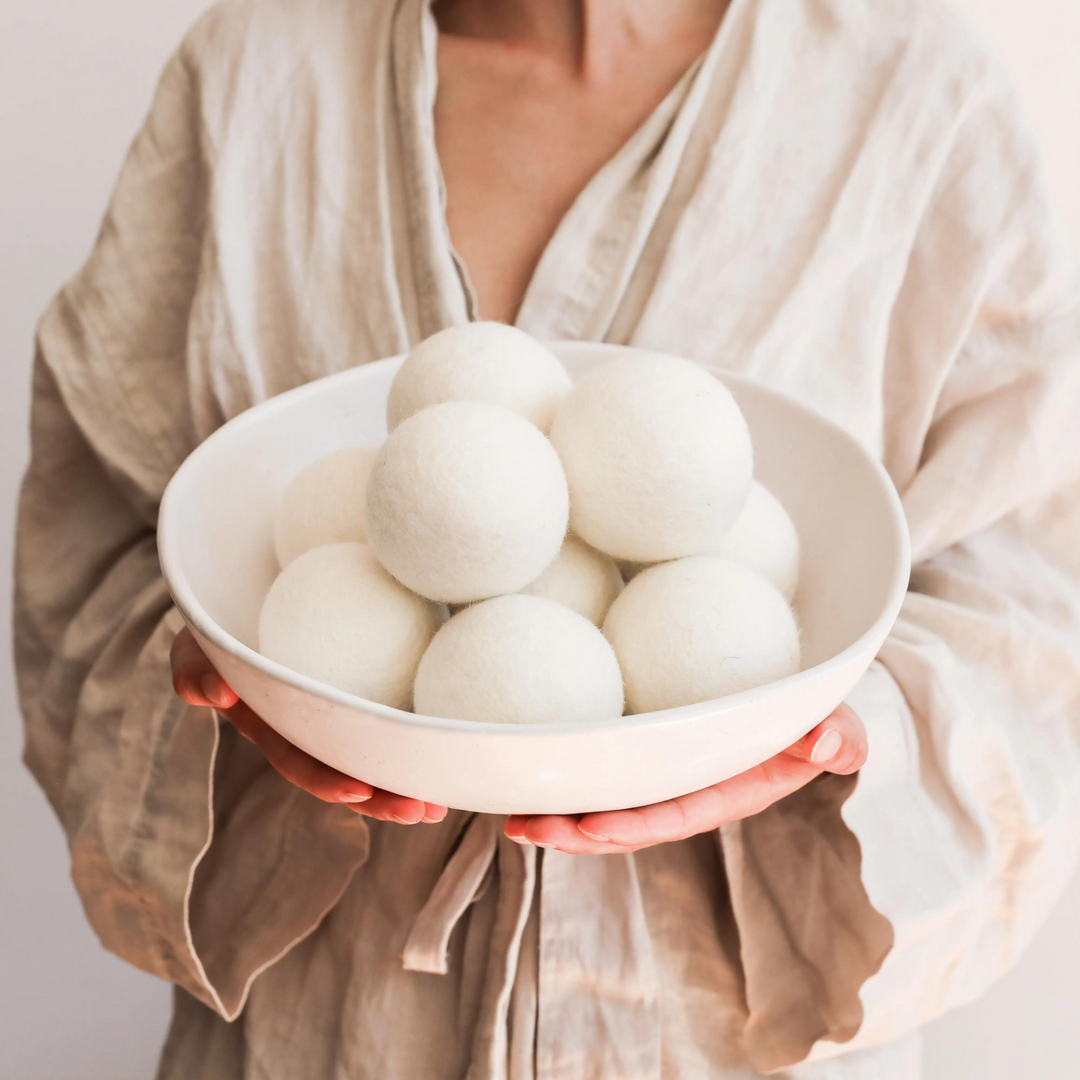 woman holding bowl of alpaca dryer balls